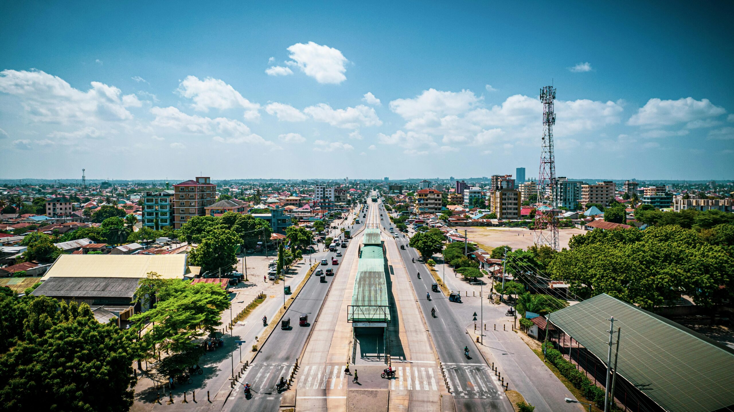 Vibrant aerial view of a main road in Dar es Salaam, Tanzania, with bustling urban landscape.